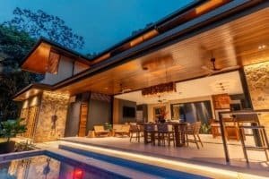 Dominical real estate: luxury outdoor living area with pool, seating, and wood ceiling.