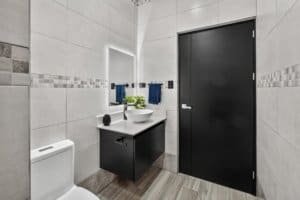 Contemporary bathroom with sink, mirror, and toilet in Costa Rica.
