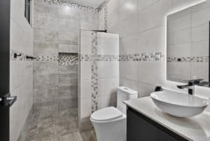 Contemporary bathroom with walk-in shower, toilet, and vessel sink.