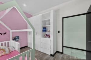 Interior of a modern home with a pink children's room and mountain views.