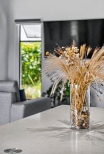 Stylish living room with dried flower arrangement and mountain views.