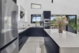 Contemporary kitchen with mountain views, sleek cabinets, and large island.