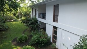 Riverfront property with guest rooms and lush garden in Dominical.