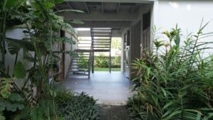 Bright, open living space with lush greenery outside.