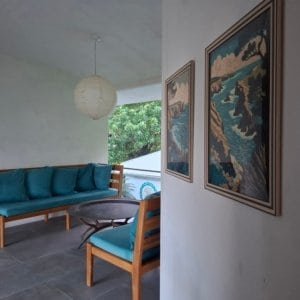 Indoor seating area with ocean view, artwork, and modern decor.