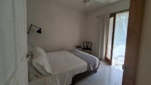 Bright bedroom with sliding glass door and outdoor view in Dominical.