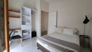 Comfortable bedroom with white walls, bed, and minimal decor in Dominical.