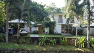 Modern house with tropical garden and palm trees in Dominical.