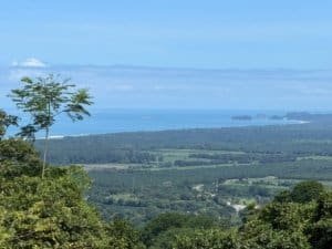 Scenic view of ocean, sunset, and lush landscape near Dominical, Costa Rica.