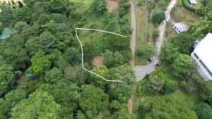 Ocean view lot with creek access, public road frontage, and utilities in Dominical.