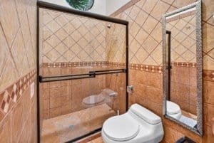 Modern bathroom with glass shower enclosure and toilet in Dominical, Costa Rica.
