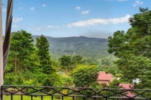 Beautiful mountain view with lush greenery and blue sky in Dominical, Costa Rica.