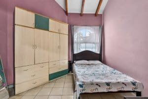 Cozy bedroom with large wardrobe and mountain view window in Dominical.