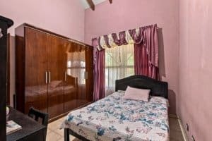 Cozy bedroom with large wardrobe and pink walls in Dominical, Costa Rica.