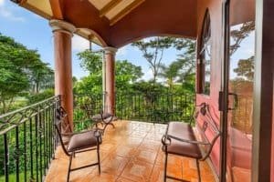 Balcony with chairs overlooking lush tropical forest in Dominical, Costa Rica.