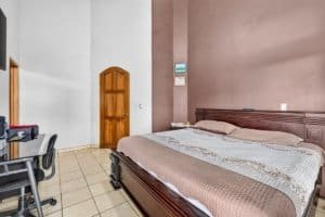 Comfortable bedroom with large bed and mountain view in Dominical.
