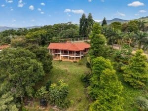 Large home with panoramic mountain views surrounded by lush greenery in Dominical.